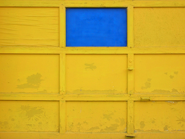 Yellow garage door with blue pane