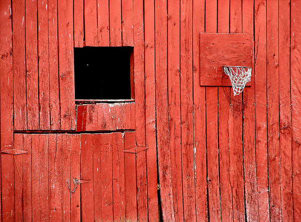 Old red building with window and basketball hoop