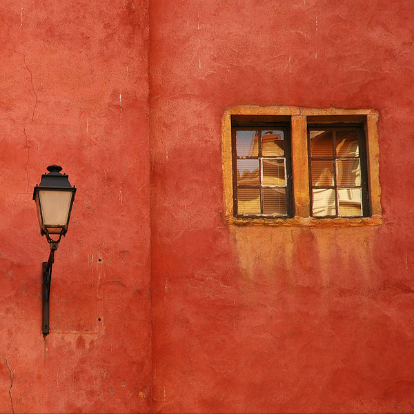 Orange wall with lamp and window