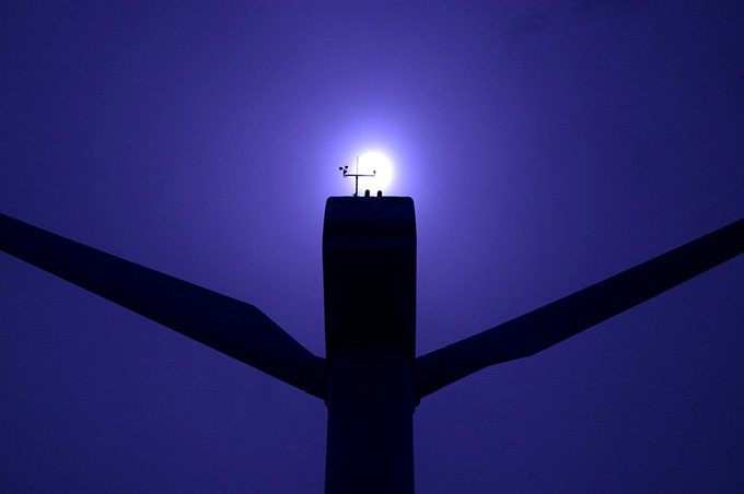 Moon appearing over a structure