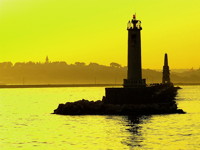 View of a silhouette lighthouse at sunset