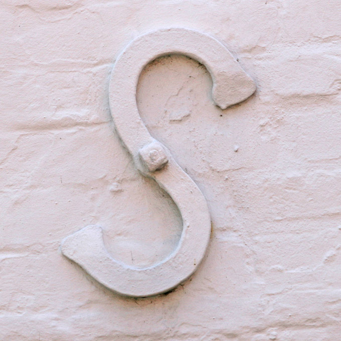 Wall fixture shaped like the letter S