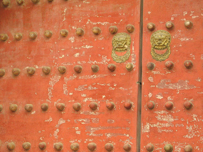 Oldd studded door with lion handles