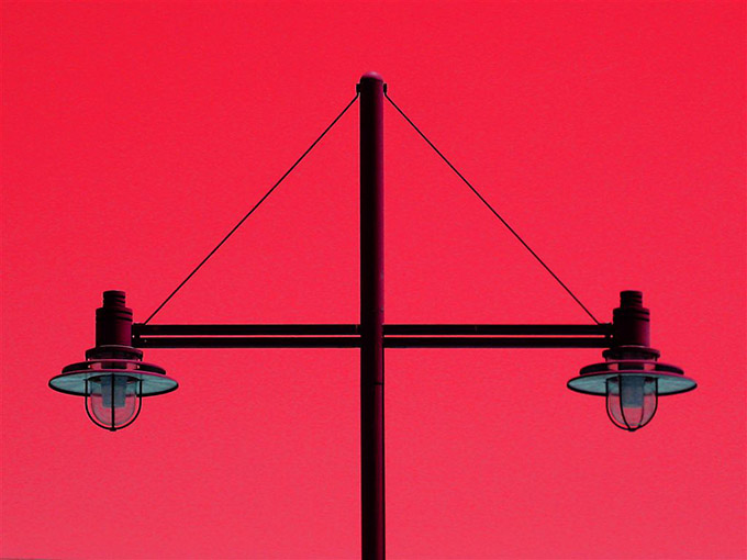 Lamp post of bright red background