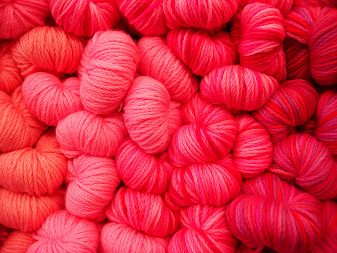 Large collection of pink/red balls of wool