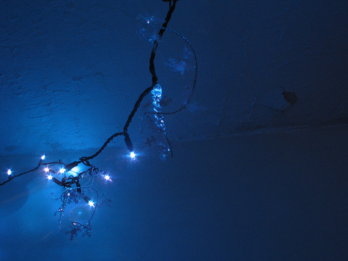 Christmas lights on a dark blue wall