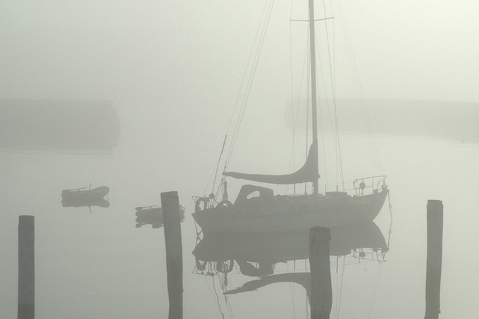 A boat on the water in fog