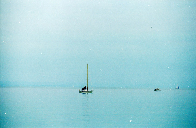 Boat on a blue water with blue sky