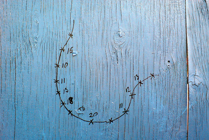 Blue wood door with flaking paint and marker drawing