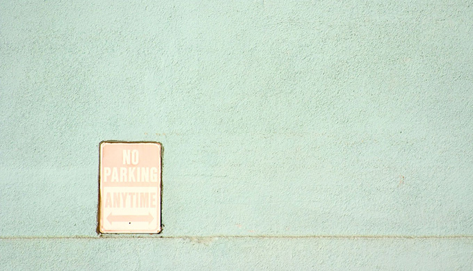 No parking sign on a mint green wall