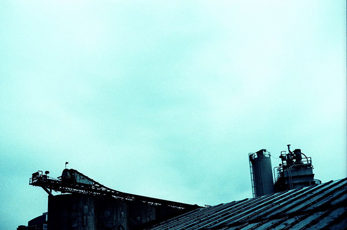 Industrial roofing against a pale blue sky