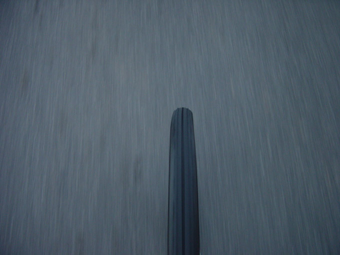 The riders view of front wheel of a bicycle