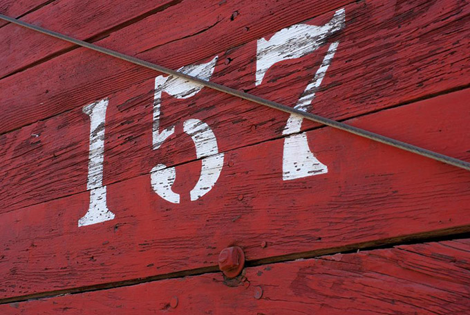 Red wood witht the number 157 painted in white